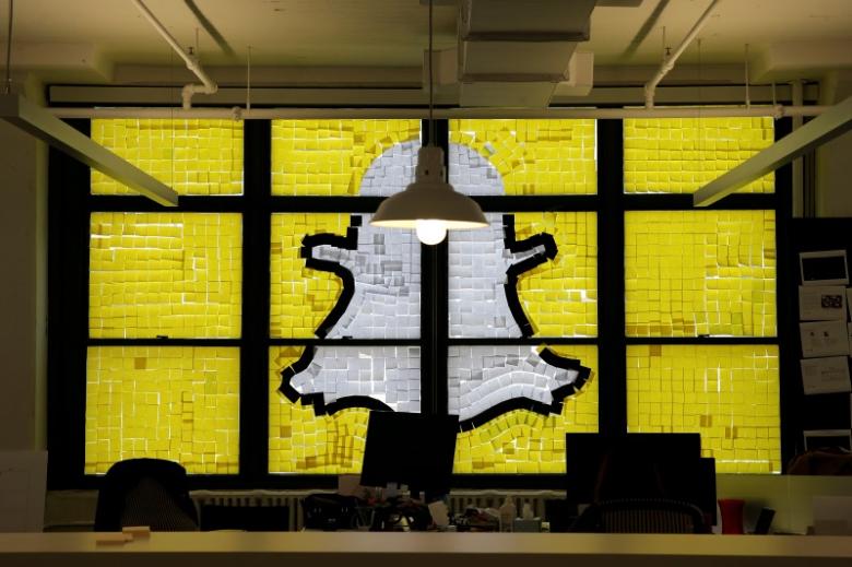 An image of the Snapchat logo created with Post-it notes is seen in the windows of Havas Worldwide at 200 Hudson Street in lower Manhattan, New York, US, May 18, 2016. REUTERS/Mike Segar