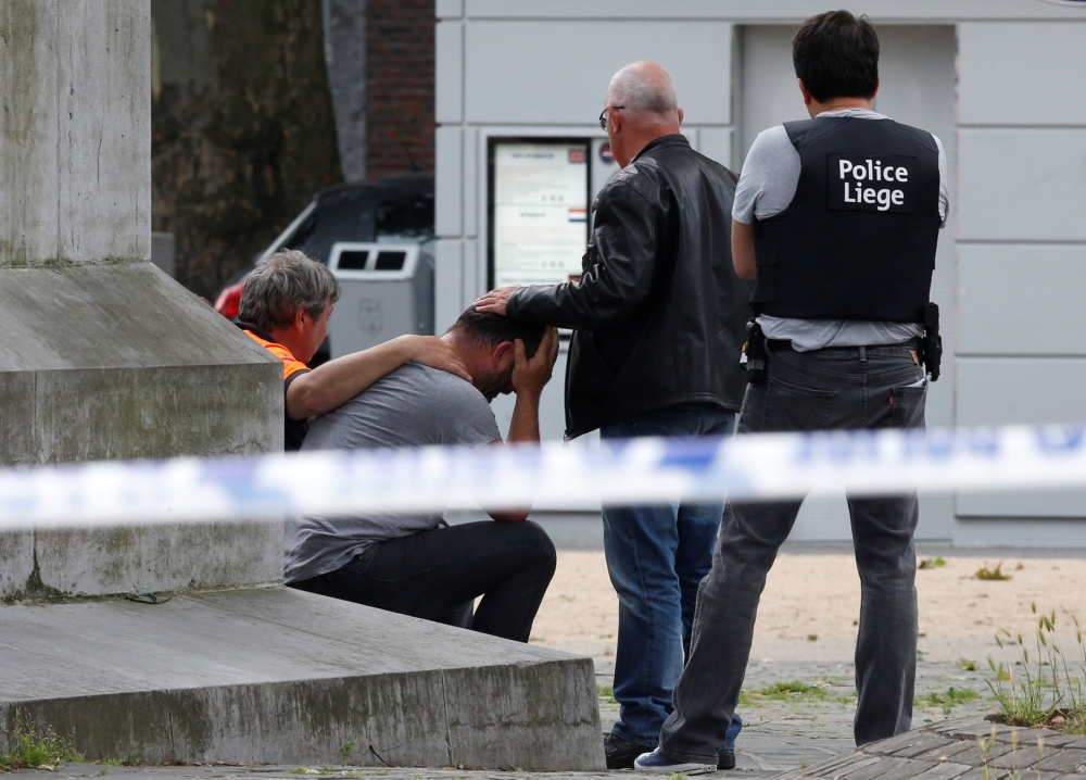 A man is being consoled on the scene of a shooting in Liege, Belgium, May 29, 2018. REUTERS/Francois Lenoir