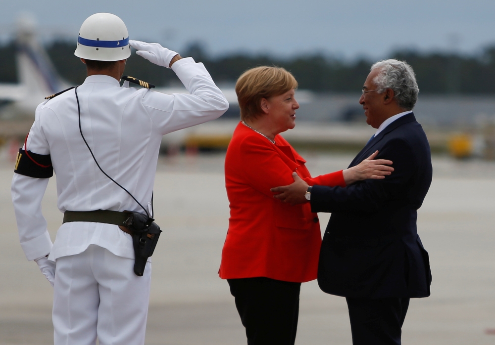 German Chancellor Angela Merkel greets Portuguese Prime Minister Antonio Costa during a welcoming ceremony at the start of a two-day official visit in Porto, Portugal, May 30, 2018. REUTERS/Pedro Nunes