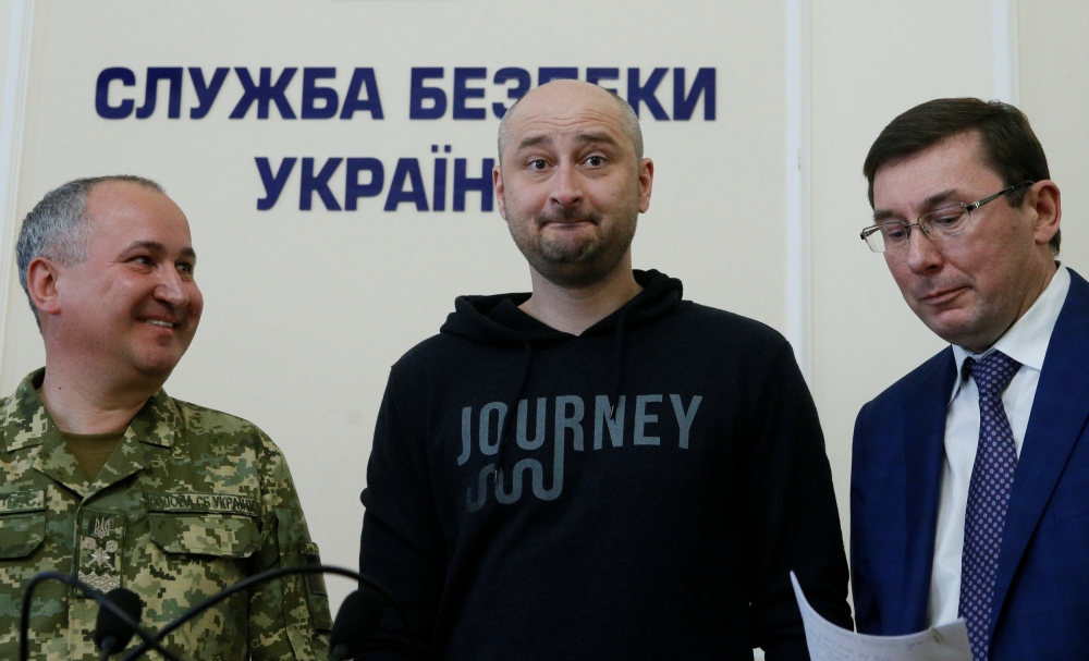 Russian journalist Arkady Babchenko (C), who was reported murdered in the Ukrainian capital on May 29, Ukrainian Prosecutor General Yuriy Lutsenko (R) and head of the state security service (SBU) Vasily Gritsak attend a news briefing in Kiev, Ukraine May 