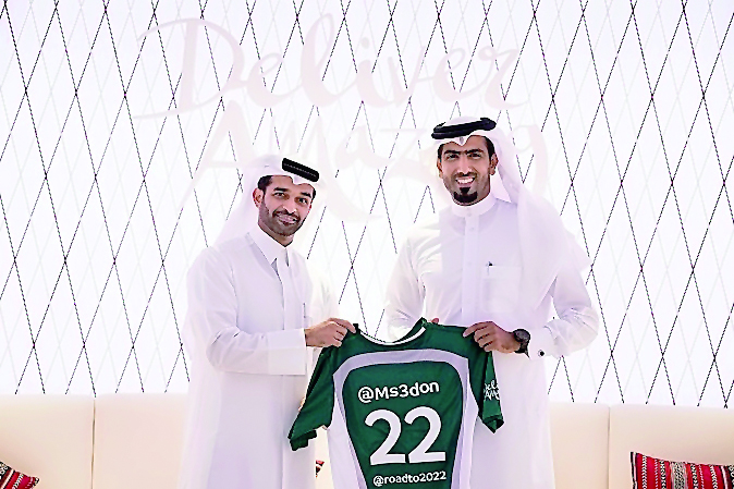 SC Secretary-General, Hassan Al Thawadi, presenting Mohammed Saadon Al Kuwari with an SC shirt to officially welcome him into the ambassador programme.