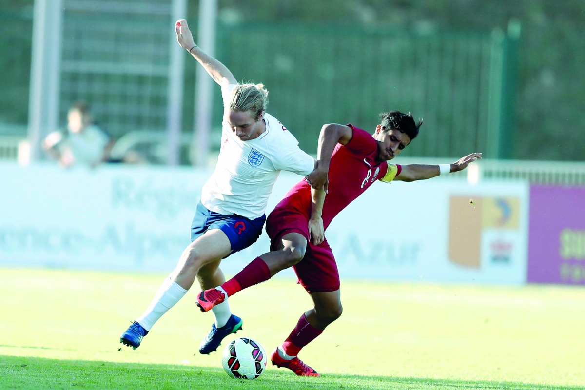 England’s Tom Davies vies for the ball with Qatar’s Nasser Abdulsalam (right) during their Toulon International Championship match played in France yesterday.
