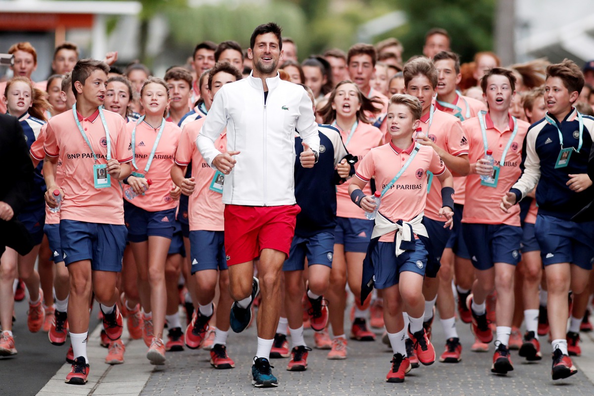 Novak Djokovic running with Ball boys and girls. Reuters/Benoit Tessier 