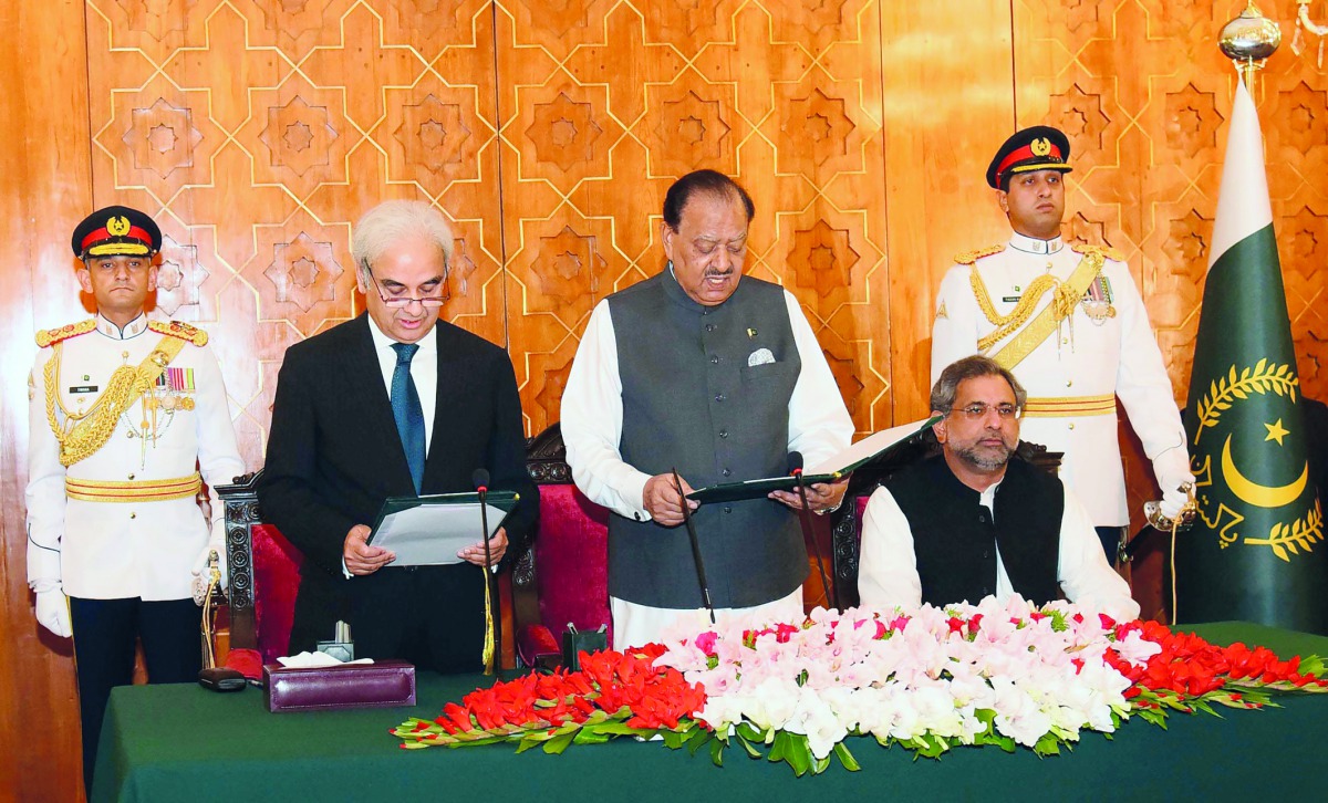 This handout photograph released by the Press Information Department (PID) on June 1, 2018, shows Pakistan's President Mamnoon Hussain (3R) administers the oath to Nasir-ul-Mulk as caretaker Prime Minister during an oath-taking ceremony at The President H