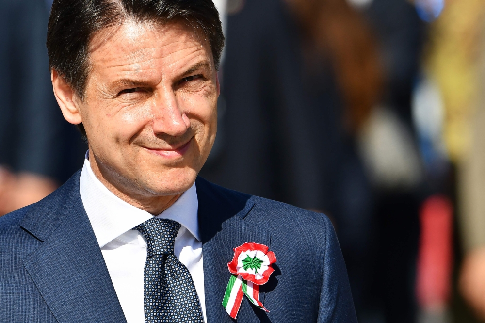 Italy’s Prime Minister Giuseppe Conte looks on as he takes part in the ceremony to mark the anniversary of the Italian Republic (Republic Day) on June 2, 2018 at Piazza Venezia in Rome. / AFP / Vincenzo PINTO