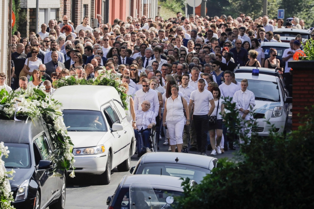 People attend on June 4, 2018 in Vottem near Liege, the funeral procession for Cyril Vangriecken, one of the three victims of a shooting the week before that prosecutors are treating as a terrorist attack. Belgium OUT / AFP / BELGA / THIERRY ROGE