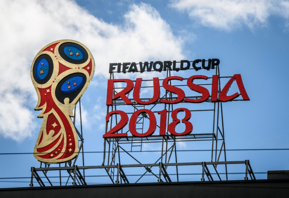 2018 FIFA World Cup logo on top of a building in Moscow. / AFP / Mladen ANTONOV
