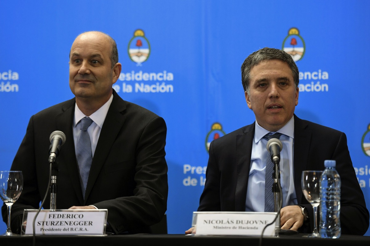 Argentina's Central Bank Governor Federico Sturzenegger (L) and Argentina's Finance Minister Nicolas Dujovne arrive for a press conference in Buenos Aires, Argentina, on June 7, 2018. AFP / Eitan Abramovich