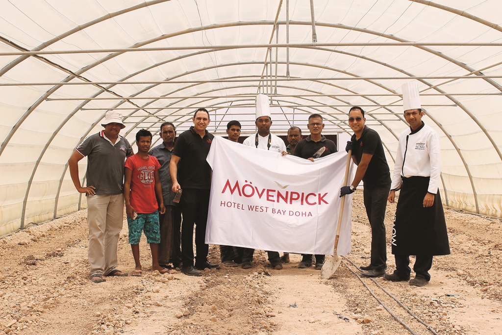 The staff of Mövenpick Hotel West Bay Doha poses after planting herbs and organic vegetables as part of its World Environment Day campaign. 