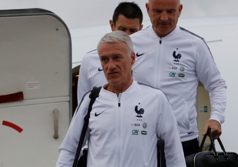 Coach Didier Deschamps and his team staff disembark from a plane. REUTERS/Tatyana Makeyeva
