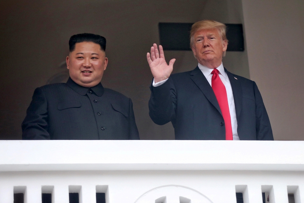 U.S. President Donald Trump waves next to North Korean leader Kim Jong Un at the Capella Hotel on Sentosa island in Singapore June 12, 2018. Kevin Lim/The Straits Times via REUTERS
