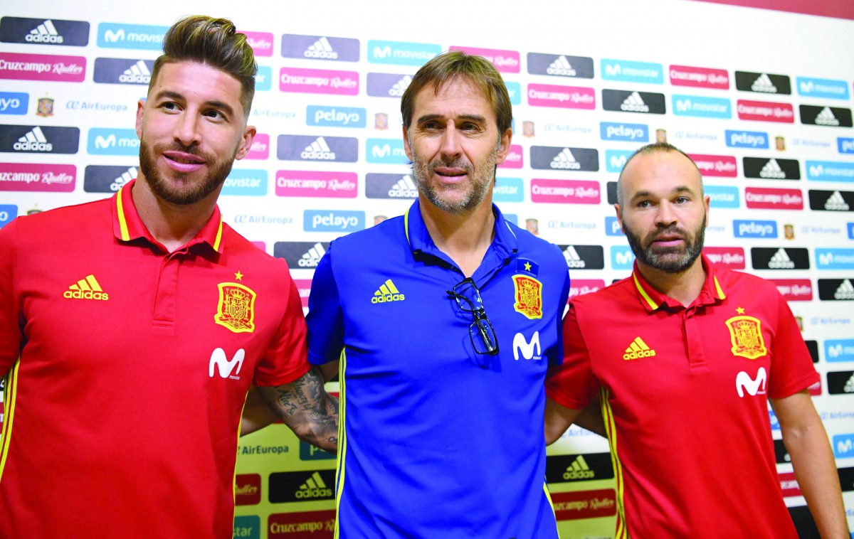 In this file photo taken on September 01, 2017 Spain’s coach Julen Lopetegui (centre) poses with Spain’s defender Sergio Ramos (left) and Spain’s midfielder Andres Iniesta prior to giving a press conference at the Royal Spanish Football Federation’s “Ciud
