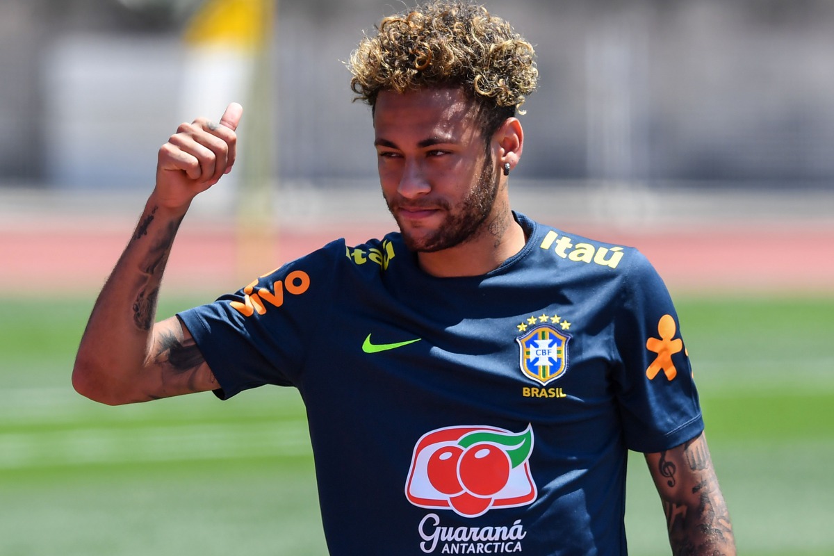 Brazil's striker Neymar greets supporters during a training session at Sochi Municipal Stadium in Sochi on June 12, 2018, ahead of the Russia 2018 World Cup football tournament. AFP / Nelson Almeida