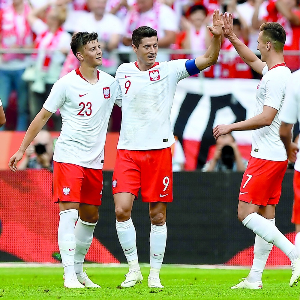 Poland's Robert Lewandowski (C), Dawid Kownacki (L) and Arkadiusz Milik react after Lewandowski scored a goal during the international friendly football match between Poland and Lithuania in Warsaw, Poland, on June 12, 2018. AFP / Janek Skarzynski