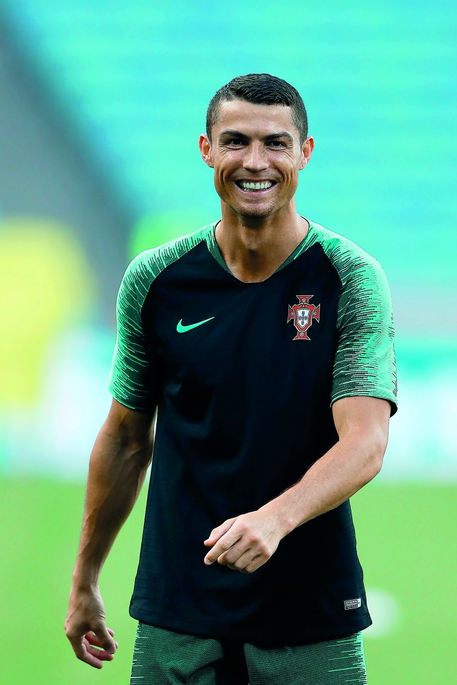 Portugal's forward Cristiano Ronaldo smiles during a training session at the Fisht Olympic Stadium in Sochi on June 14, 2018, on the eve of the Russia 2018 World Cup Group B football match between Portugal and Spain. AFP / Adrian Dennis