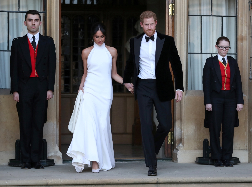 File photo of the newly married Duke and Duchess of Sussex, Meghan Markle and Prince Harry, leaving Windsor Castle after their wedding to attend an evening reception at Frogmore House, hosted by the Prince of Windsor, Britain, May 19, 2018. Steve Parsons/