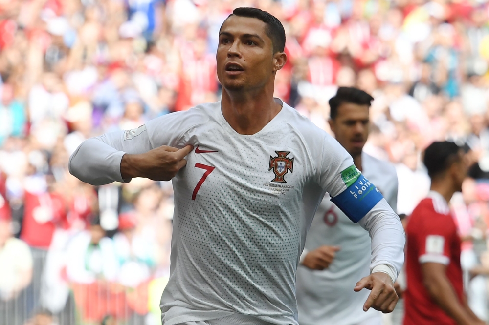 Portugal's forward Cristiano Ronaldo celebrates his opening goal for Portugal during the Russia 2018 World Cup Group B football match between Portugal and Morocco at the Luzhniki Stadium in Moscow on June 20, 2018. AFP / Francisco LEONG 
