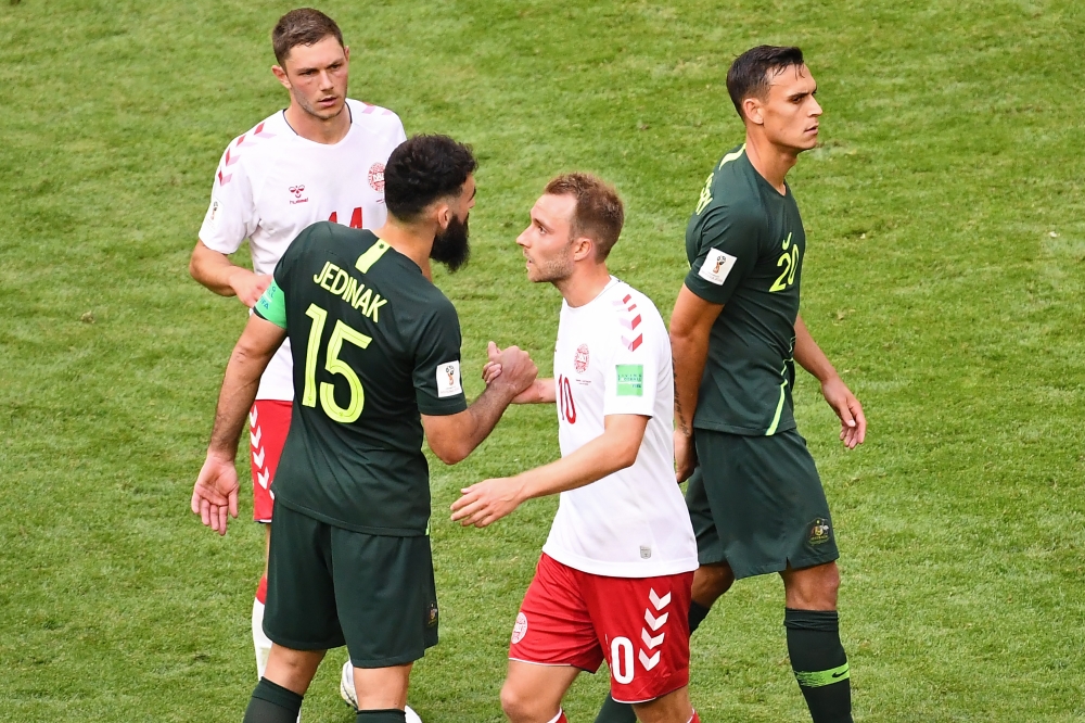 Australia's midfielder Mile Jedinak (2L) shakes hands with Denmark's midfielder Christian Eriksen (2R) after the Russia 2018 World Cup Group C football match between Denmark and Australia at the Samara Arena in Samara on June 21, 2018. (AFP / EMMANUEL DUN