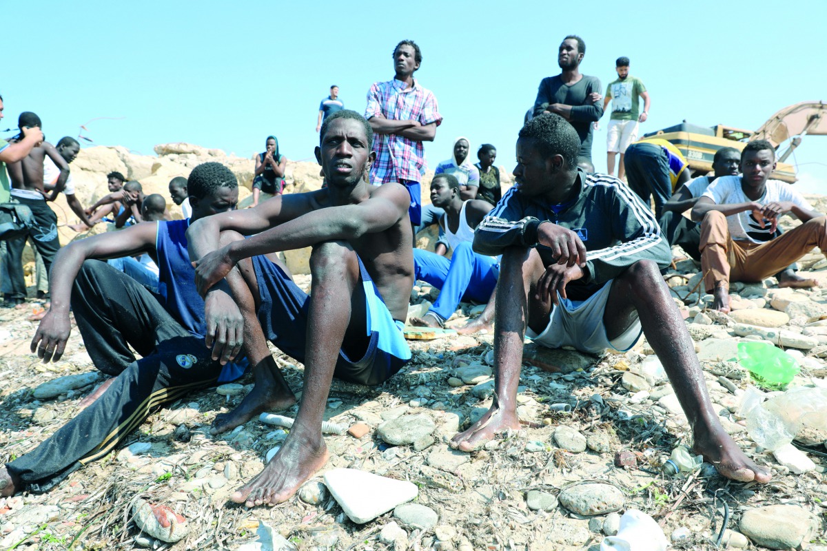 Migrants wait to be transported to a detention center, at the coast of Tajoura, east of Tripoli, Libya June 20, 2018. Reuters/Hani Amara