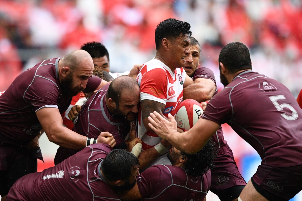Japan's centre Timothy Lafaele (C) is tackled by Georgian players during the rugby union Test match between Japan and Georgia at Toyota Stadium in Toyota on June 23, 2018. / AFP / Martin BUREAU