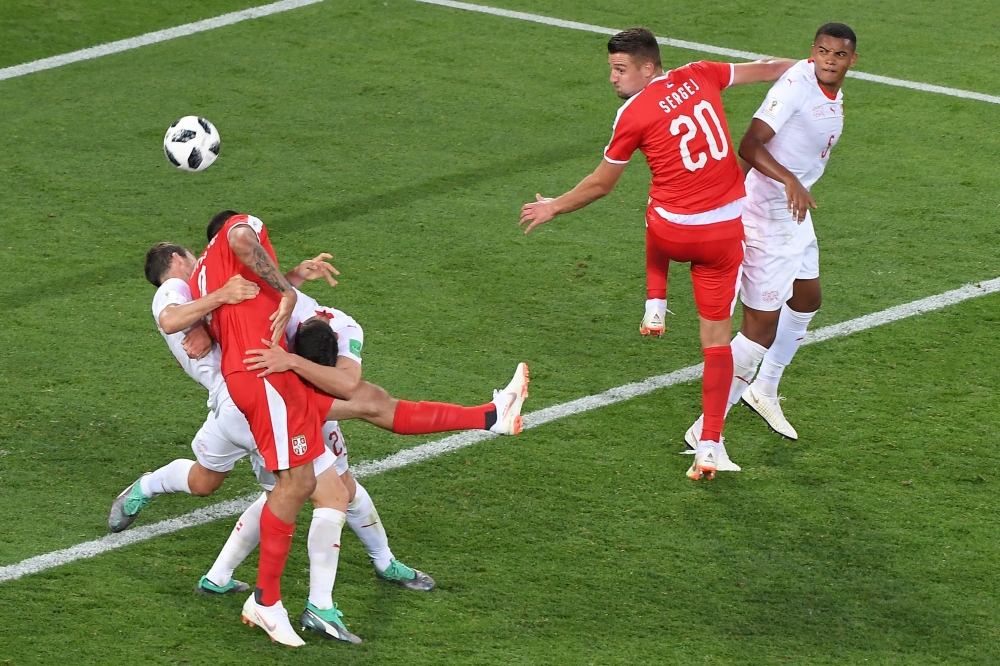 Serbia's forward Aleksandar Mitrovic (2L) vies for the ball with Serbia's midfielder Adem Ljajic (3L) and Switzerland's defender Stephan Lichtsteiner (L) during the Russia 2018 World Cup Group E football match between Serbia and Switzerland at the Kalinin
