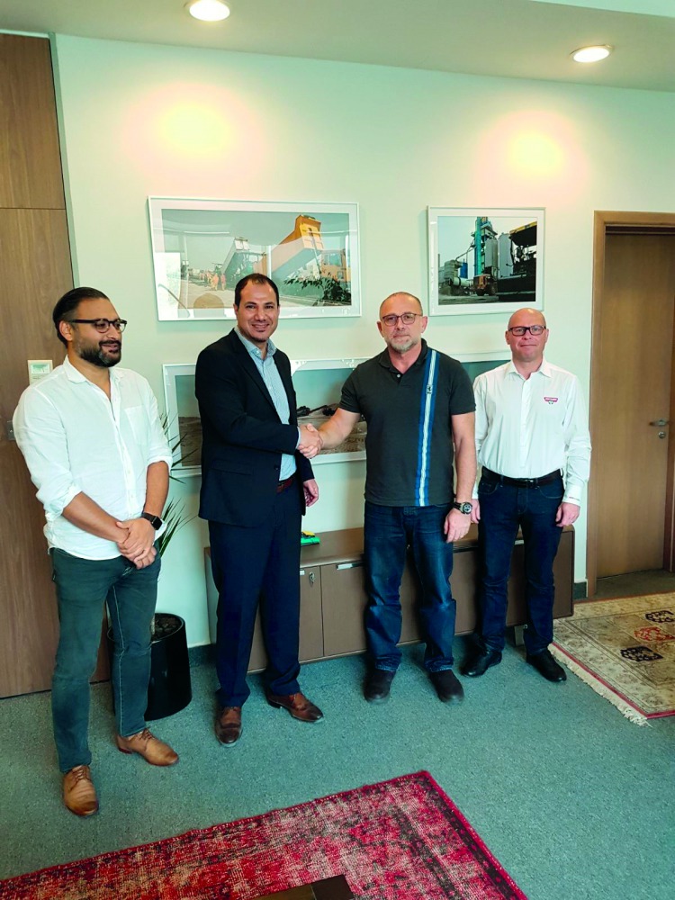 The staff of  Nasser Bin Khaled  Heavy Equipment and QBS pose after expanding their successful collaboration. 