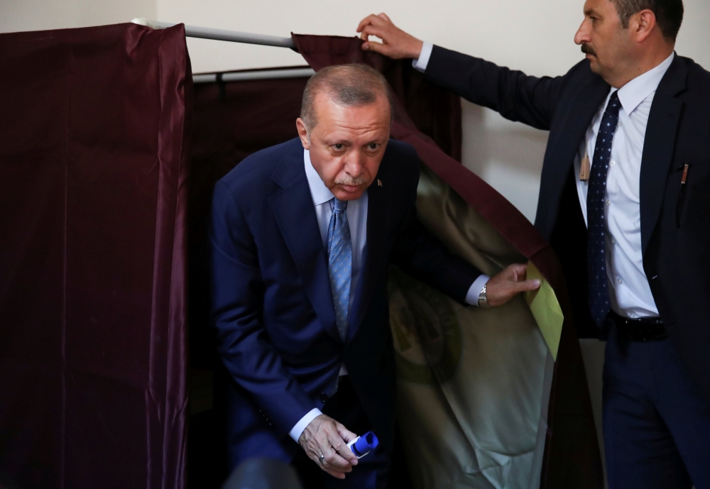 Turkish President Tayyip Erdogan leaves the voting booth at a polling station in Istanbul, Turkey June 24, 2018. REUTERS/Umit Bektas