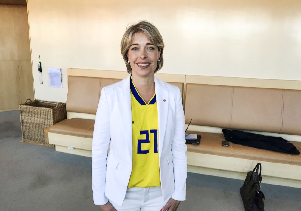 Sweden's Minister for Social Affairs Annika Strandhall poses, wearing Sweden's national soccer team jersey with number 21 assigned to Jimmy Durmaz, at the Parliament House in Stockholm, Sweden, June 27, 2018. (TT News Agency/Lars Larsson via REUTERS)