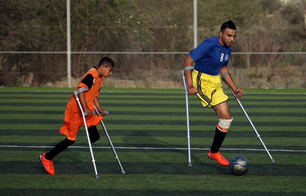 Members of a Palestinian amputee football team, which is made up of players most of who lost their legs in the conflict with Israel, play a game on a soccer pitch in the central Gaza Strip June 21, 2018. Picture taken June 21, 2018. Reuters/Ibraheem Abu M