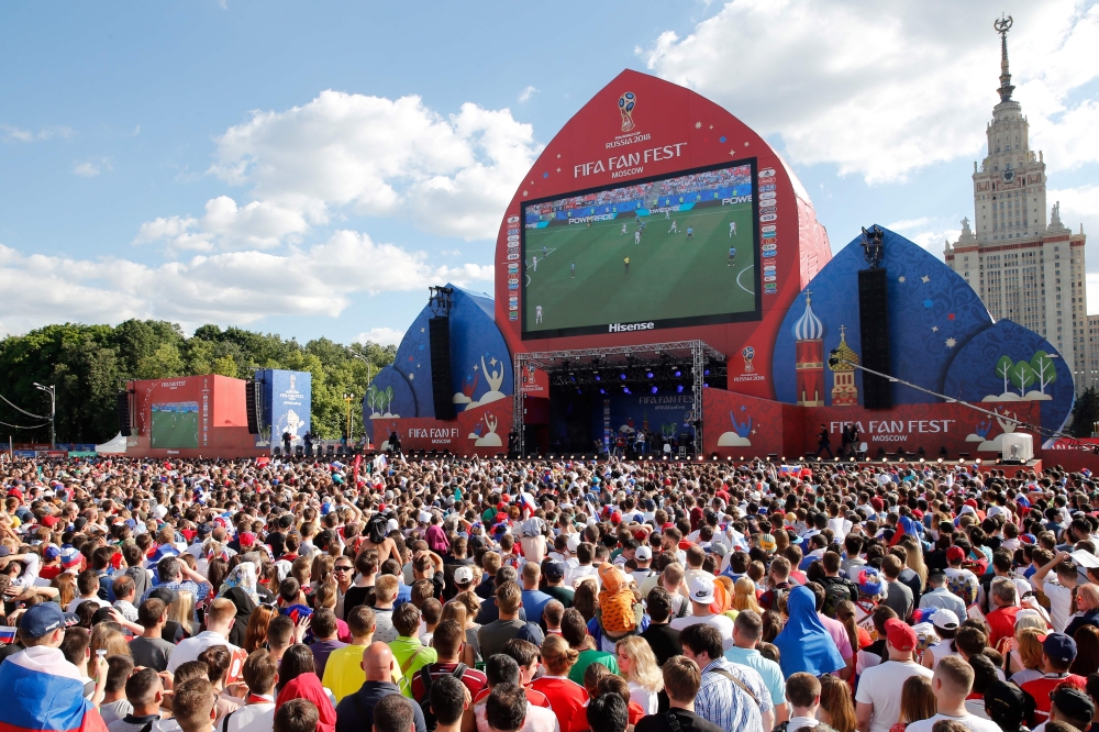( FILE PHOTO ) Russia and Uruguay's fans watch on a giant screen the Russia 2018 World Cup Group A football match between Uruguay and Russia, at the fan zone in Moscow on June 25, 2018. / AFP / Maxim ZMEYEV
