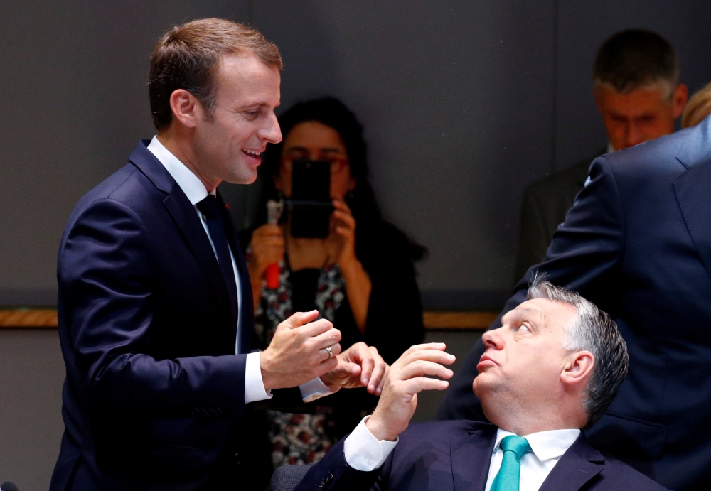 File photo: French President Emmanuel Macron talks to Hungarian Prime Minister Viktor Orban as they arrive at a European Union leaders summit in Brussels, Belgium June 29, 2018. REUTERS/Francois Lenoir/File Photo