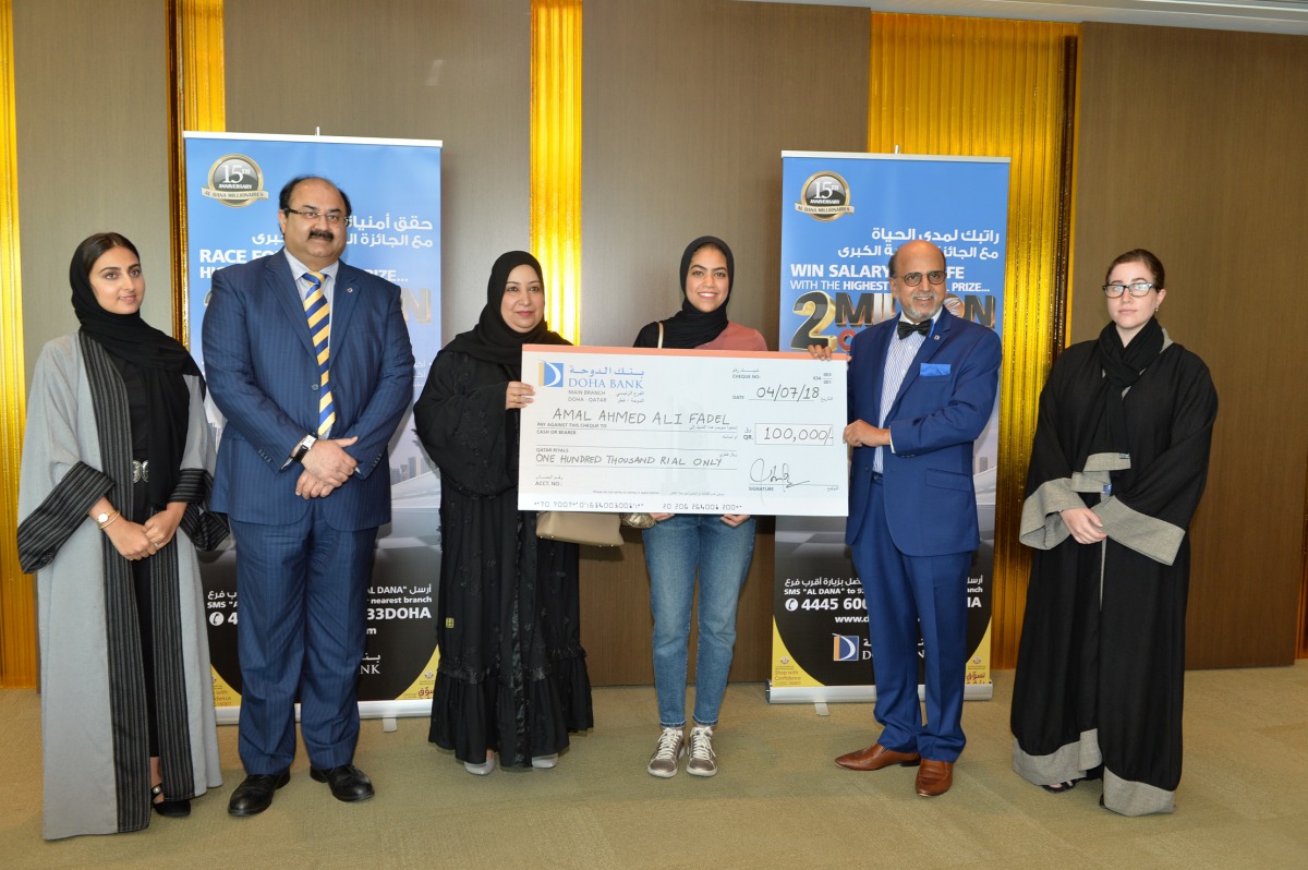 Dr R Seetharaman (second right), CEO of Doha Bank, with other officials of the bank and winners of the fourth draw of Al Dana Savings Scheme, at the bank’s branch in Dar Al Salam Mall.