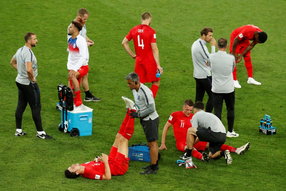 England's Harry Maguire and Jamie Vardy receive medical attention, Colombia vs England, Spartak Stadium, Moscow, Russia, July 3, 2018. Reuters/Christian Hartmann