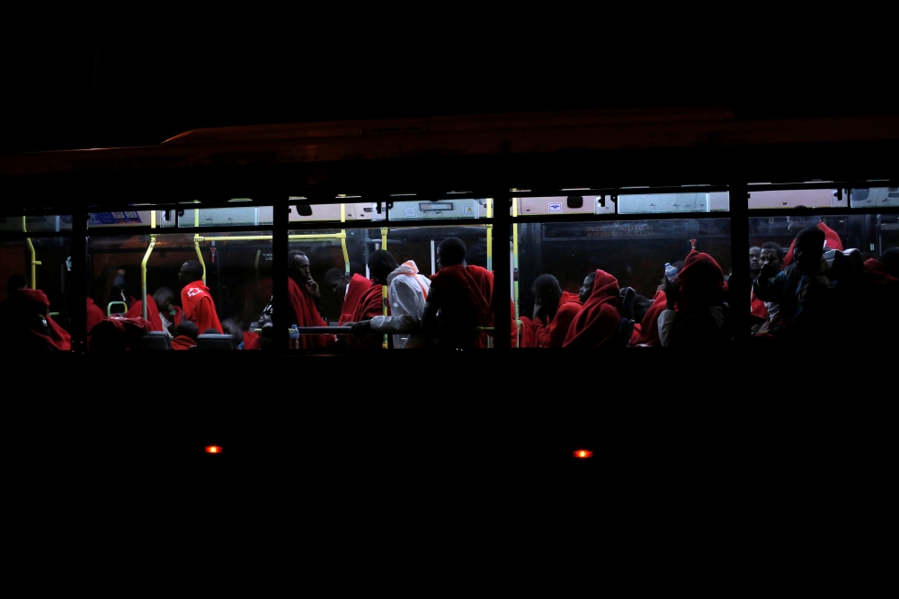 Migrants intercepted aboard five dinghies off the coast in the Mediterranean Sea, are seen in a bus moving towards a sports center after arriving on a rescue vessel at the port of Malaga, southern Spain July 9, 2018. Reuters/Jon Nazca