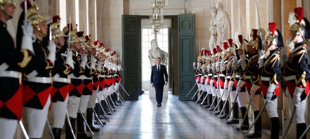 French President Emmanuel Macron walks through the Galerie des Bustes (Busts Gallery) to access the Versailles Palace's hemicycle to address both the upper and lower houses of the French parliament (National Assembly and Senate) at a special session in Ve