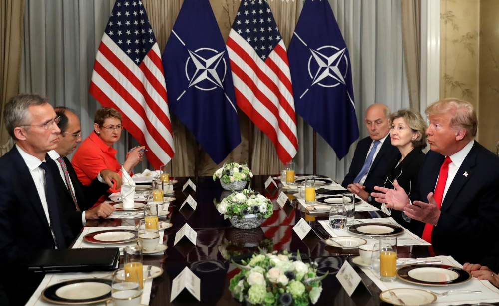 U.S. President Donald Trump holds a breakfast meeting with NATO Secretary General Jens Stoltenberg (L) at the NATO Summit in Brussels, Belgium, July 11, 2018. REUTERS/Kevin Lamarque