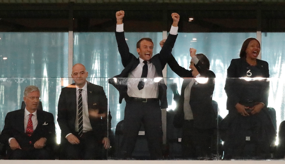 President of France Emmanuel Macron (C) celebrates as King Philippe of Belgium (L) looks on alongside FIFA president Gianni Infantino at the end of the match. (REUTERS/Toru Hanai)