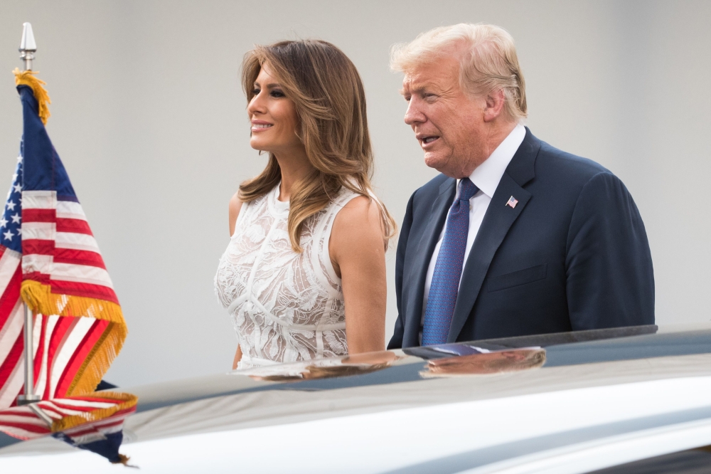 US President Donald Trump (R) and First Lady of the US Melania Trump arrive for a working dinner at The Parc du Cinquantenaire - Jubelpark Park in Brussels on July 11, 2018, during the North Atlantic Treaty Organization (NATO) summit. / AFP / POOL / BENOI