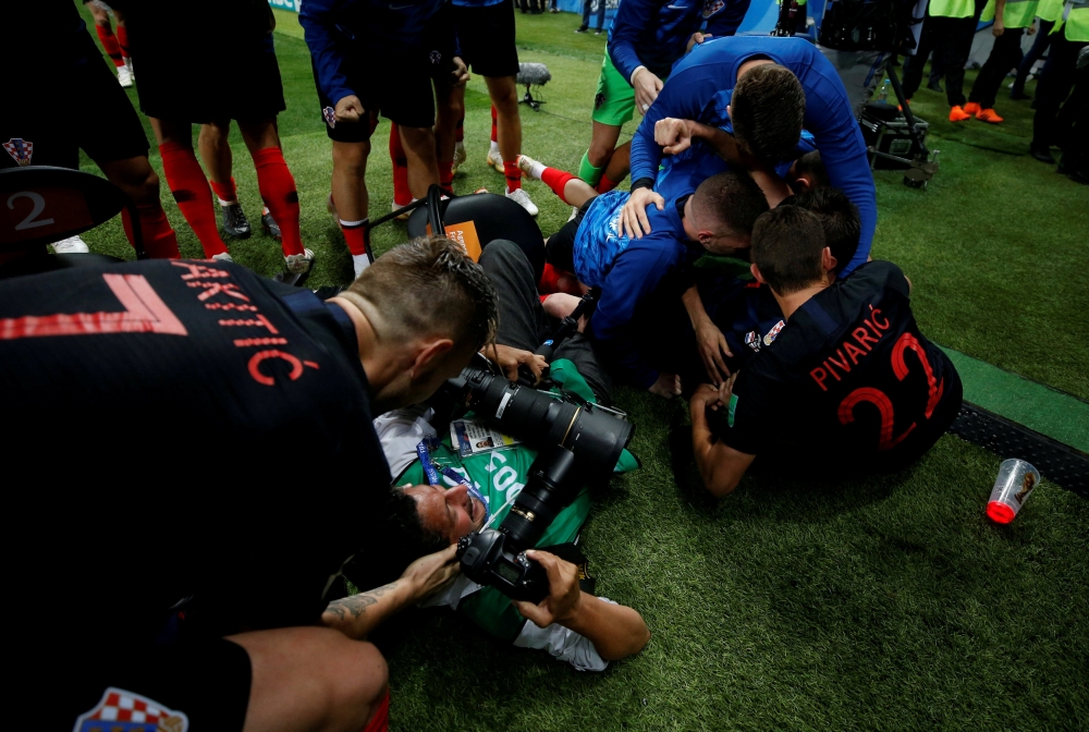 Croatia players celebrate next to an AFP photographer Yuri Cortez after Mario Mandzukic scores their second goal. Reuters/Carl Recine