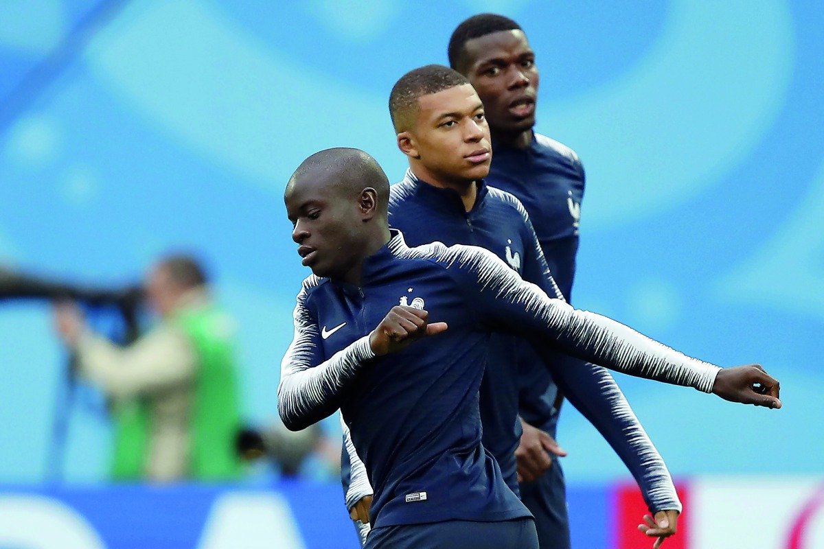 French midfielder N’Golo Kante (front), Kylian Mbappe (centre) and Paul Pogba warm up at the Saint Petersburg Stadium in Saint Petersburg in this file photo. 