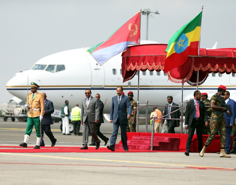Eritrea's President Isaias Afwerki is welcomed by Ethiopian Prime Minister Abiy Ahmed upon arriving for a three-day visit, at the Bole international airport in Addis Ababa, Ethiopia July 14, 2018. REUTERS/Tiksa Negeri