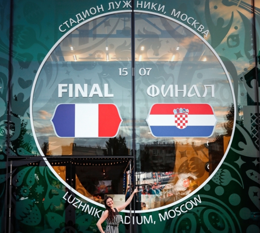 A fan poses for a photo in front of 2018 FIFA World Cup museum's wall ahead of the final match of the 2018 FIFA World Cup between France and Croatia at Luzhniki Stadium in Moscow, Russia on July 14, 2018. ( ?ebnem Co?kun - Anadolu Agency )