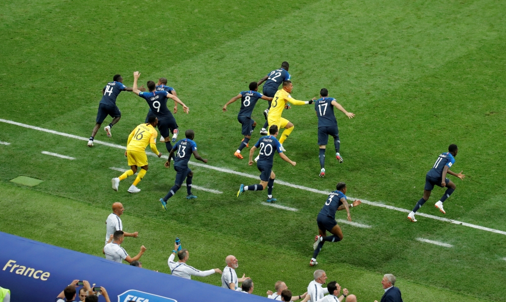 France substitutes run onto the pitch as they celebrate winning the World Cup. Reuters/Maxim Shemetov

