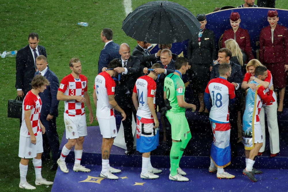 Croatia players receive their runners up medals from FIFA president Gianni Infantino, President of Russia Vladimir Putin, President of France Emmanuel Macron and President of Croatia Kolinda Grabar-Kitarovic during the medals presentation. Reuters/Maxim S