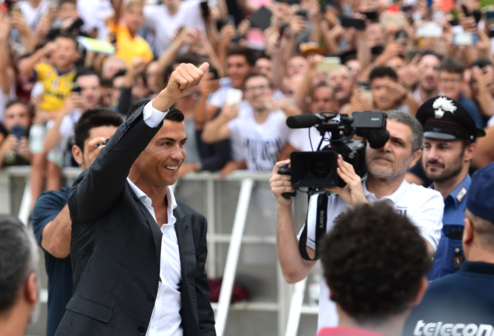 Portuguese attacker Cristiano Ronaldo gestures as he arrives on July 16, at the Juventus medical center at the Alliance stadium in Turin. Cristiano Ronaldo arrived in Turin ahead of his official unveiling as Juventus' superstar summer signing on July 17. 