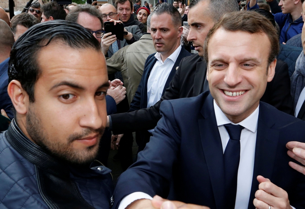Emmanuel Macron (R) flanked by Alexandre Benalla (L), head of security, attends a campaign visit in Rodez, France, May 5, 2017. REUTERS/Regis Duvignau/File picture