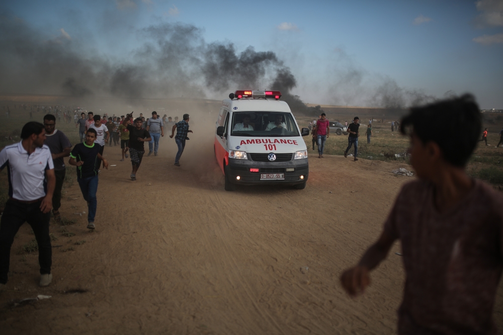 An ambulance takes a wounded to the hospital as as Israeli forces intervene to disperse Palestinians taking part in the 