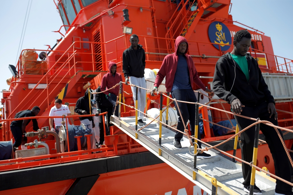 Migrants, intercepted aboard toy dinghies off the coast in the Strait of Gibraltar, leave a rescue boat after arriving at the port of Algeciras, southern Spain July 21, 2018. Reuters/Jon Nazca

