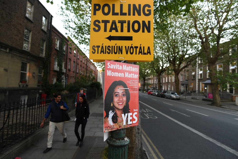 A Pro-Choice poster featuring Savita Halappanavar is placed near a sign for a polling station ahead of a 25th May referendum on abortion law in Dublin, May 23, 2018. (Reuters / Clodagh Kilcoyne) 