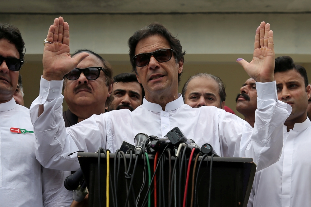 Cricket star-turned-politician Imran Khan, chairman of Pakistan Tehreek-e-Insaf (PTI), speaks to members of media after casting his vote at a polling station during the general election in Islamabad, Pakistan, July 25, 2018. Reuters/Athit Perawongmetha